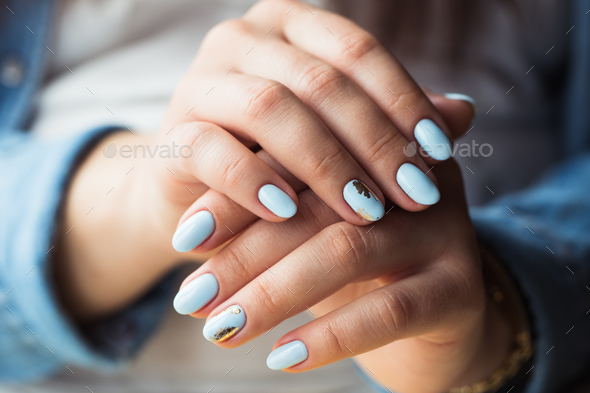 beautiful manicure. Gel polish coating in blue, embossing.