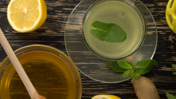 Ginger Tea with Lemon, Mint and Honey on Wooden Background.