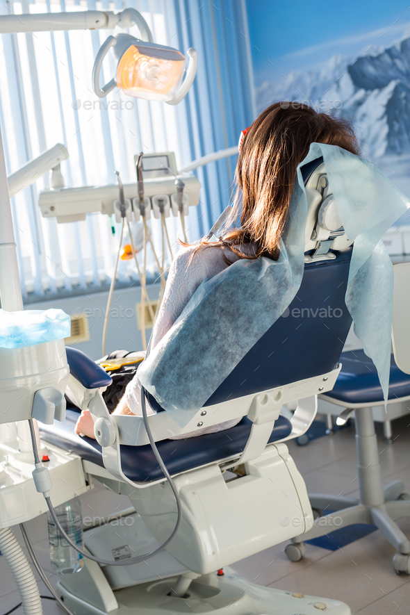 Patient Sitting On Dental Chair, Waiting For Her Dentist Stock Photo By 