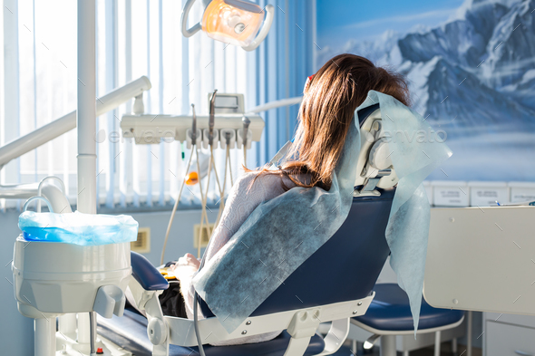 Patient sitting on dental chair, waiting for her dentist Stock Photo by ...