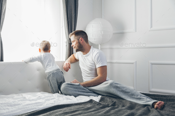 Father with his son looking out of the window - Stock Photo - Images
