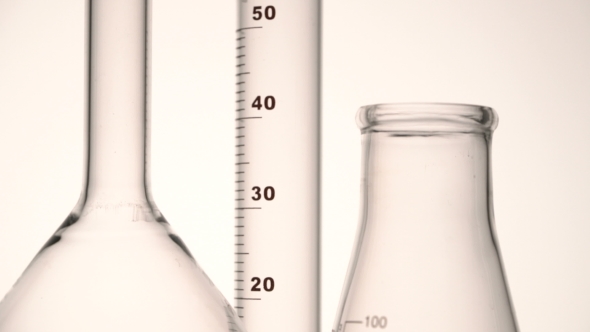 Empty Chemical Glass Flasks and Test Tube Against White Background