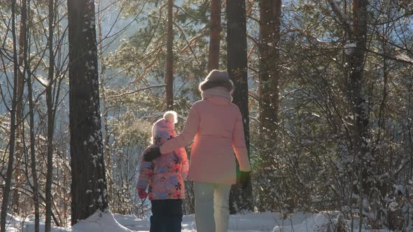Little Girl with Mom Walking in Frosty Winter Day alt