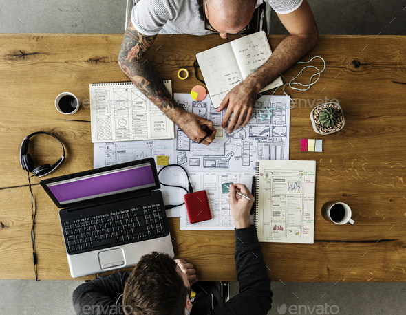 Colleagues Working on Web Design Startup Together on Wooden Tabl - Stock Photo - Images