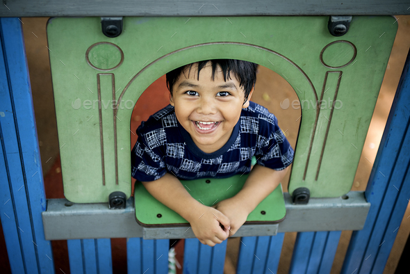 Young boy playing in playground - Stock Photo - Images