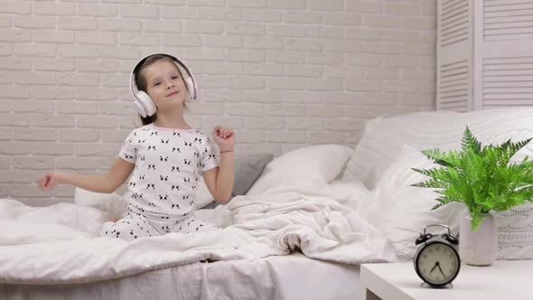 Little Child Baby Girl Listening To the Music with Headphones