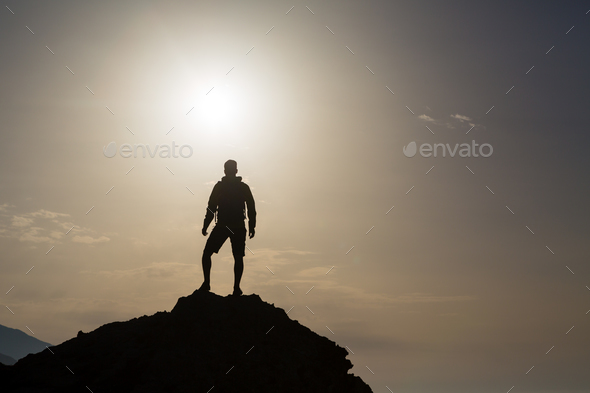 Man looking and celebrating sunrise and landscape - Stock Photo - Images
