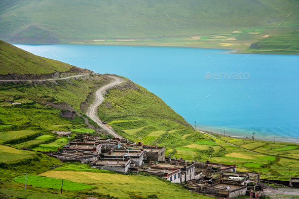 Traditional tibetan homes above Yamdrok Tso Lake lake - Stock Photo - Images