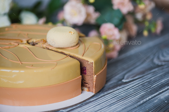 Bakery with piece of unusual yellow mousse cake with almond dacquoise, raspberry confit, crispy
