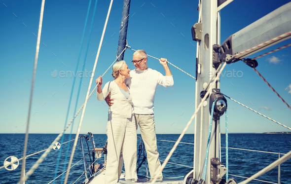 senior couple hugging on sail boat or yacht in sea - Stock Photo - Images