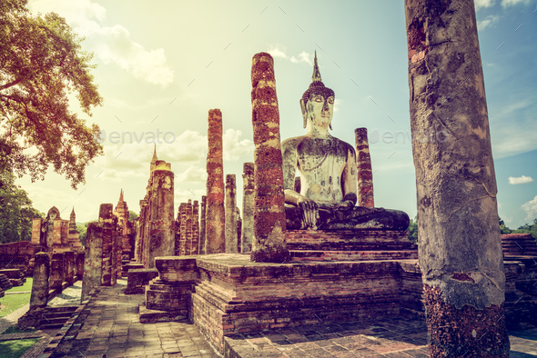 Vintage buddha statue among the ruins - Stock Photo - Images