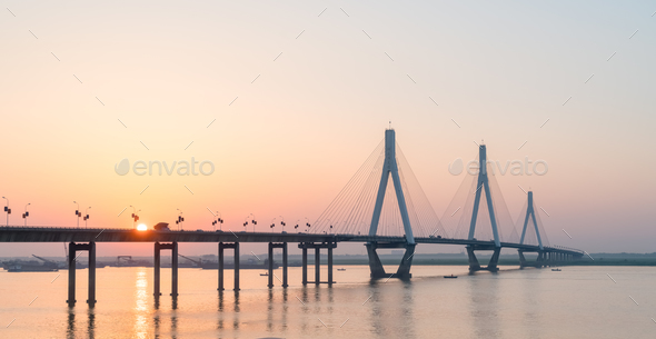 cable stayed bridge with setting sun - Stock Photo - Images