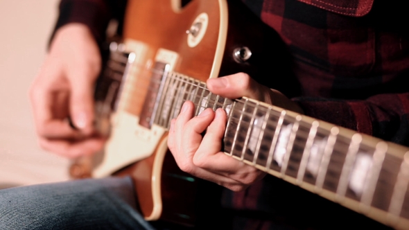 Fingers Playing Guitar