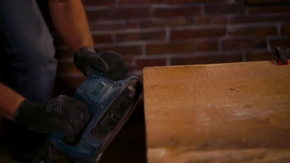 Close Up Shot of a Man's Hands, Who Works with Carpentry Tools in Protective Gloves alt