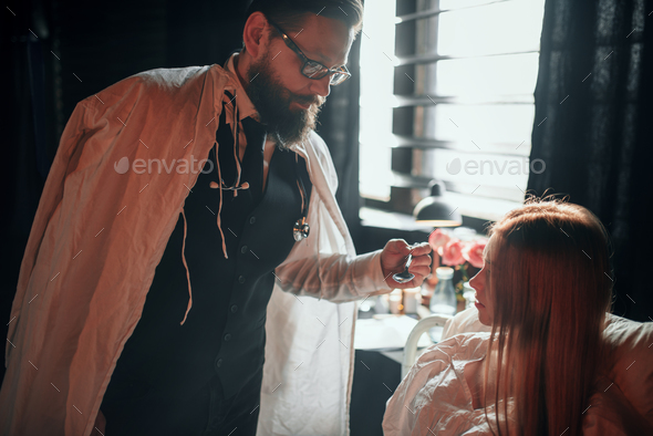Doctor gives the medicine to sick female patient - Stock Photo - Images