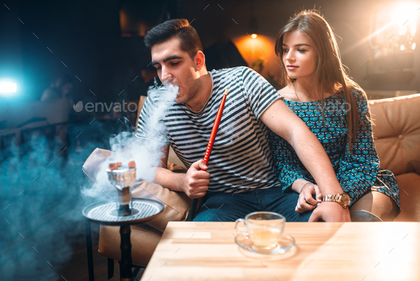 Young couple relax and smoking hookah Stock Photo by NomadSoul1 | PhotoDune