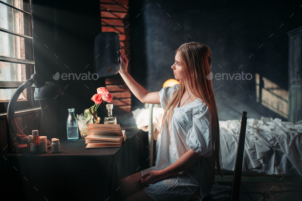 Sick woman looking at x-ray picture in hospital - Stock Photo - Images