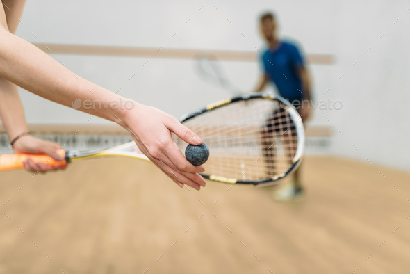 Couple play squash game in indoor training club - Stock Photo - Images