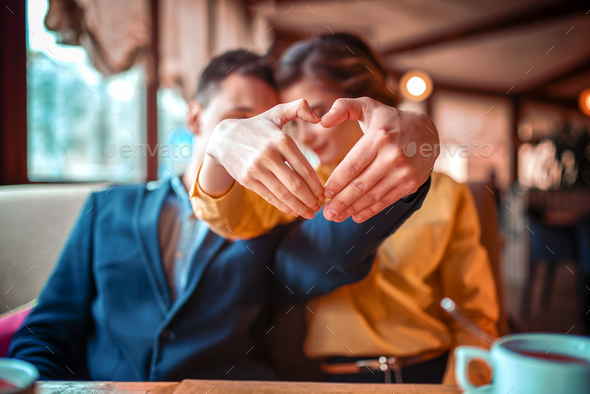 Love couple makes a heart with hands - Stock Photo - Images