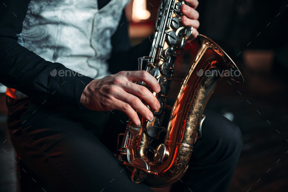 Jazz man hands holding saxophone closeup - Stock Photo - Images