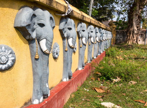 Wall with elephant sculptures in buddha temple Stock Photo by NomadSoul1