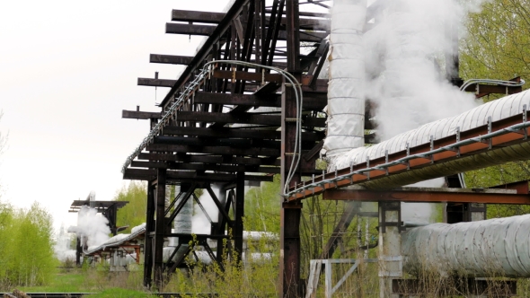 Industrial Pipelines on Pipe-bridge From Which Emanate Jets of Steam