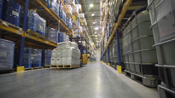 Worker Transporting Cargo on Forklift alt
