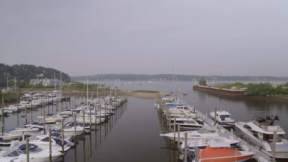 Flying Over Boats Docked at Marina in Hempstead Harbor on a Cloudy Day alt