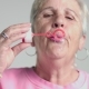 Eldery Woman Blow Bubbles To Camera - VideoHive Item for Sale
