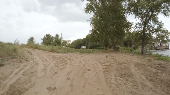 Car Driving Along a Rural Dirt Road