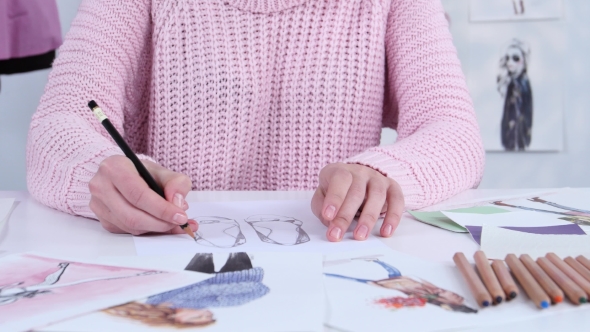 Designer Dress Hands Create Beautiful Drawings with Pencils for the Clothing Magazine. alt