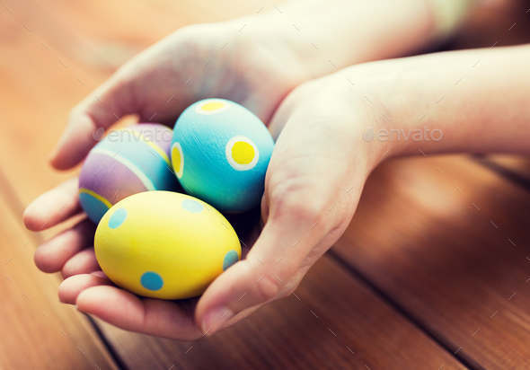 close up of woman hands with colored easter eggs - Stock Photo - Images