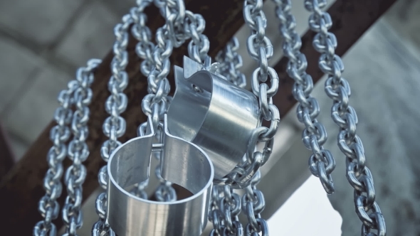 Chains with Shackles Hanging in an Abandoned Building alt
