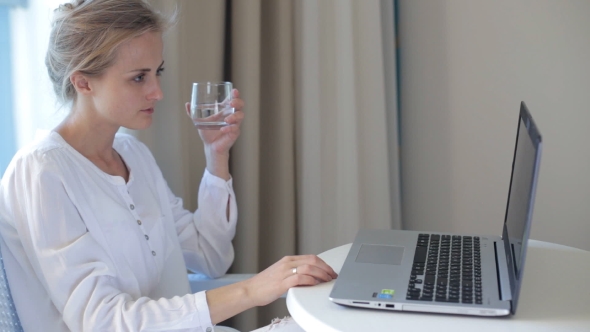 Woman Working on Computer and Drink
