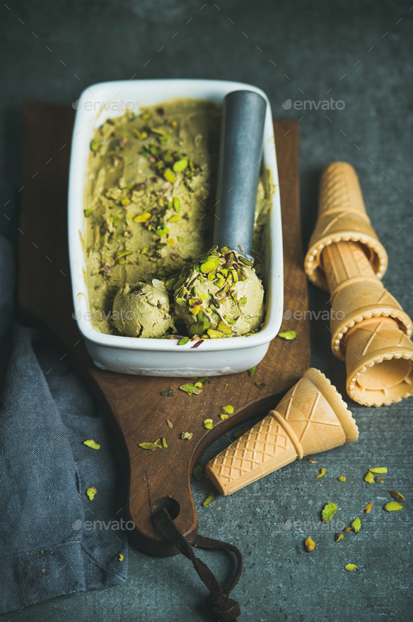 Homemade pistachio ice cream in ceramic mold over grey background - Stock Photo - Images