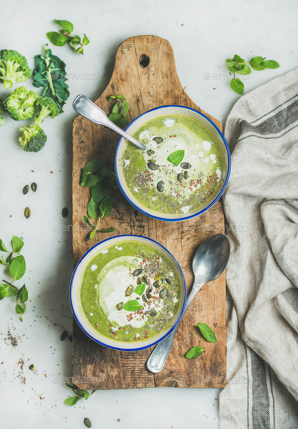 Spring vegetarian broccoli cream soup with mint and coconut cream - Stock Photo - Images