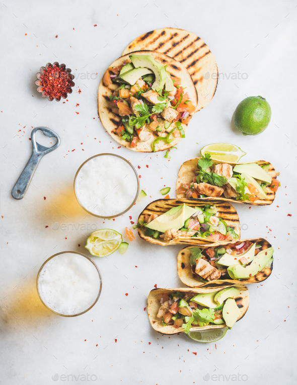 Healthy corn tortillas with chicken, vegetables, limes, beer in glasses - Stock Photo - Images