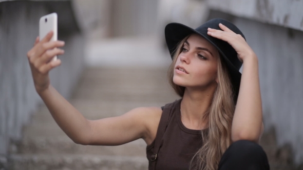 Young Beautiful Girl in a Black Hat Smiling