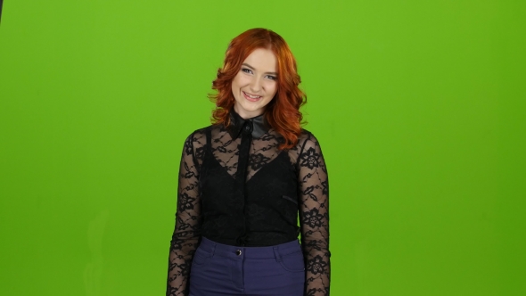 Girl Is a Passive, She Shows Her Finger Up with Both Hands, Smiles, Dances. Green Screen alt