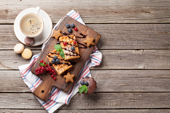 Coffee, sweets and waffles with berries - Stock Photo - Images