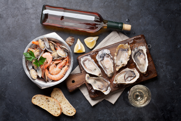 Fresh seafood and white wine on stone table - Stock Photo - Images