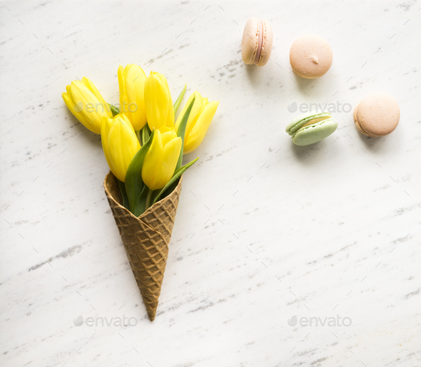 Tulips in ice cream cone on marble background Stock Photo by sianstock
