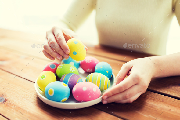 close up of woman hands with colored easter eggs - Stock Photo - Images