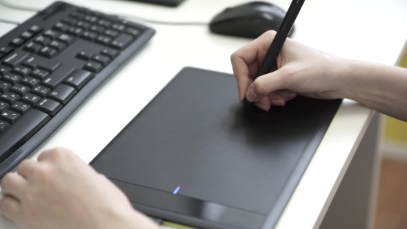 Graphic Designer Using Drawing Tablet