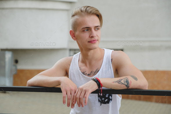 Hipster handsome blonde man guy in stylish summer clothes in the street Stock Photo by arthurhidden