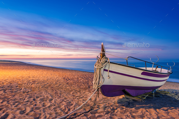 Old wooden fishing boat on beach at sunrise Stock Photo by merc67
