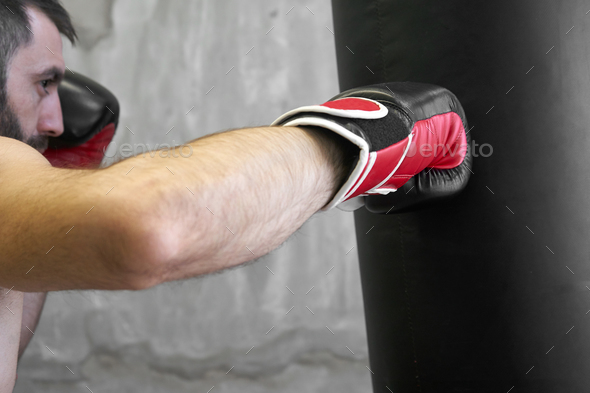 Boxer man doing exercise with punching bag Stock Photo by sianstock