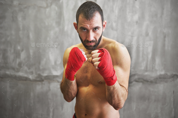 Shot of wrapped hands with red boxing tape of young boxer fight Stock Photo by sianstock