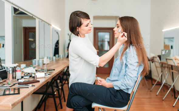 Female make up artist work with woman face