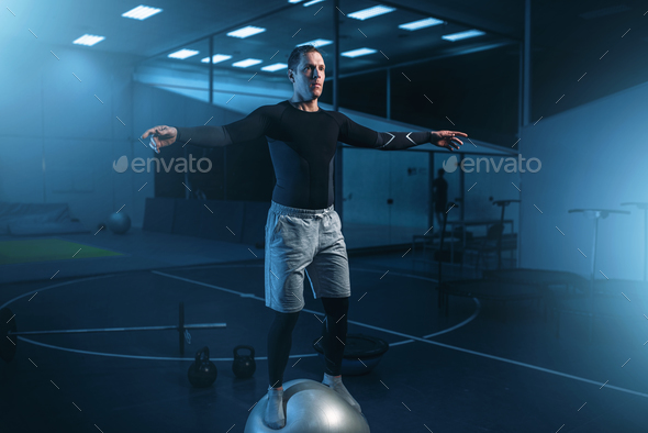 Man on training, balance workout with bouncy ball